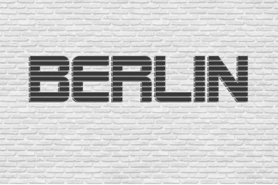 Banner Berlin Schriftzug an weißer Steinwand als Textilbanner oder PVC-Banner